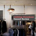 person leaning on wall while holding gray hat