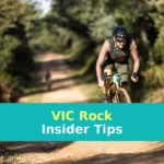 A man riding a bike down a dirt road