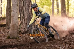 a man riding a mountain bike through a forest