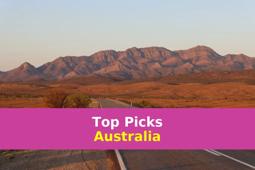 gray concrete road near brown mountains during daytime