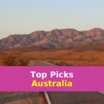 gray concrete road near brown mountains during daytime
