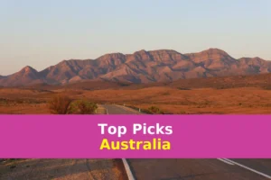 gray concrete road near brown mountains during daytime
