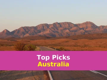gray concrete road near brown mountains during daytime