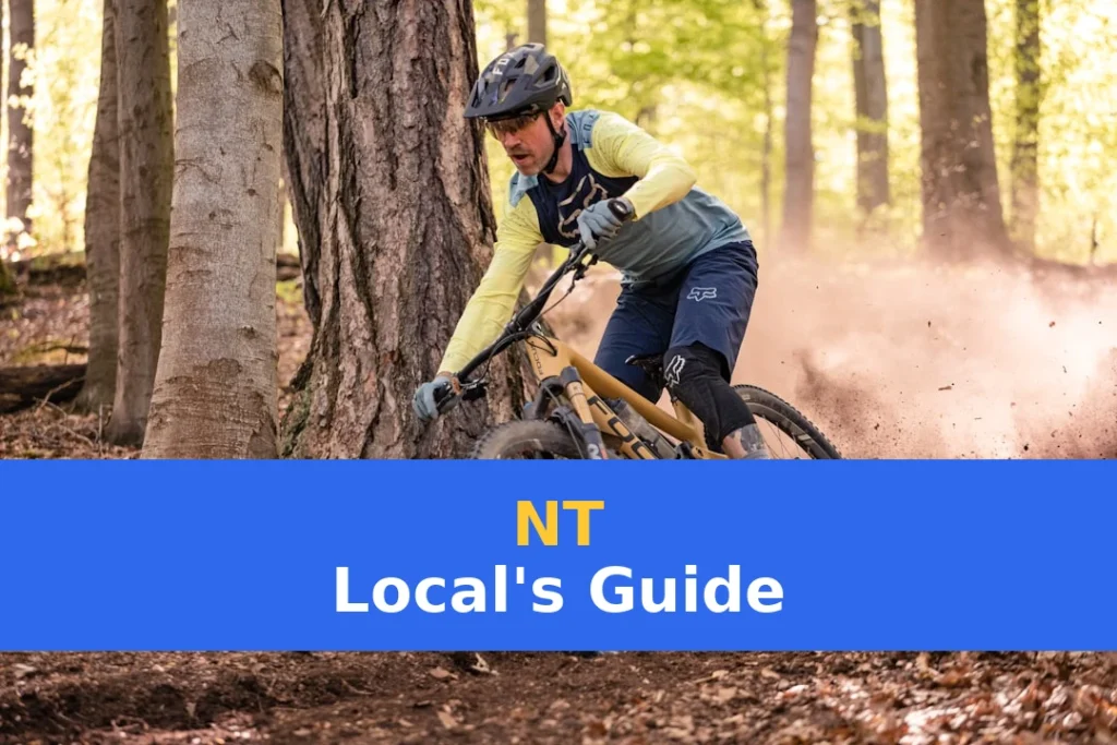 a man riding a mountain bike through a forest