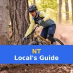 a man riding a mountain bike through a forest