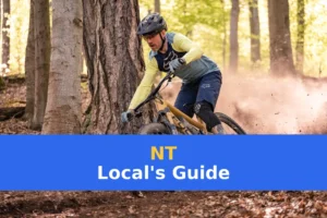 a man riding a mountain bike through a forest