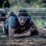 man crawling on barb wire