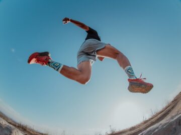 man leaping while trail running